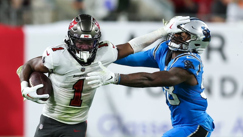 Tampa Bay Buccaneers running back Rachaad White pushes off Carolina Panthers linebacker...