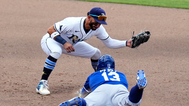Kansas City Royals' Salvador Perez (13) slides into second base ahead of the tag by Tampa Bay...