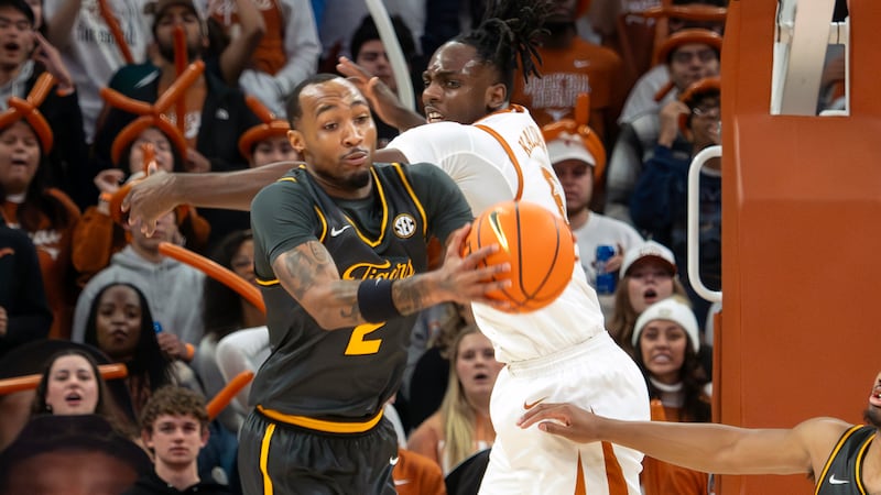 Missouri guard Tamar Bates, left, pulls down a rebound against Texas forward Arthur Kaluma,...