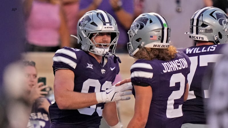 Kansas State tight end Will Swanson, left, celebrates with quarterback Avery Johnson (2) after...