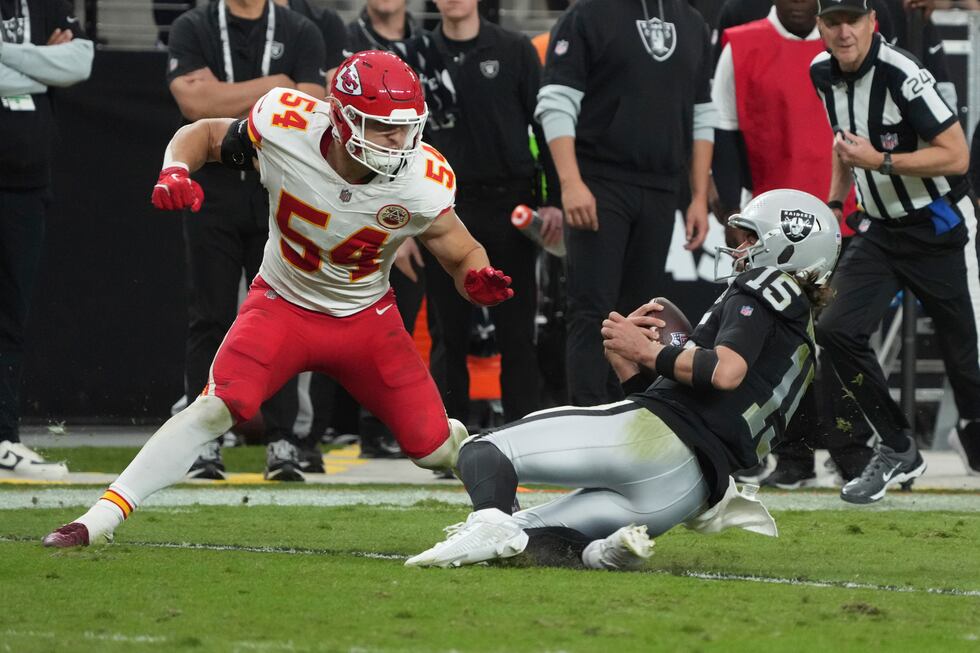 Las Vegas Raiders quarterback Gardner Minshew (15) slides for yardage as Kansas City Chiefs...