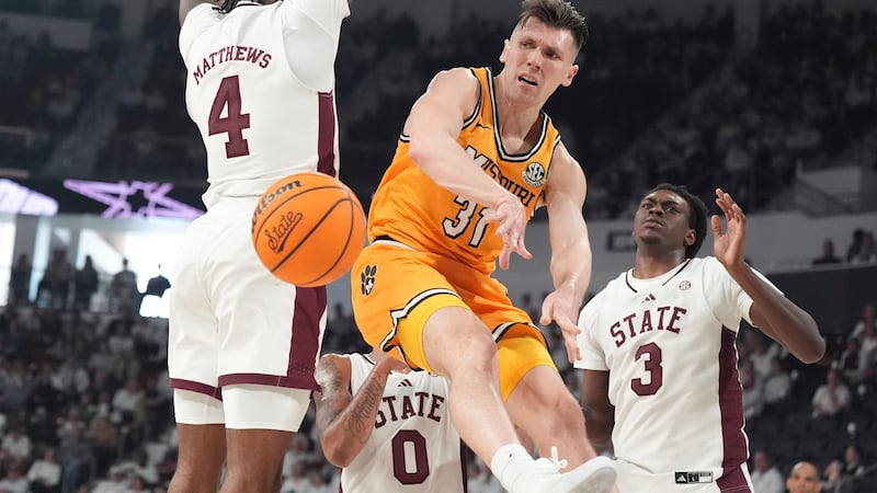Missouri guard Caleb Grill (31) passes the ball around Mississippi State forward Cameron...