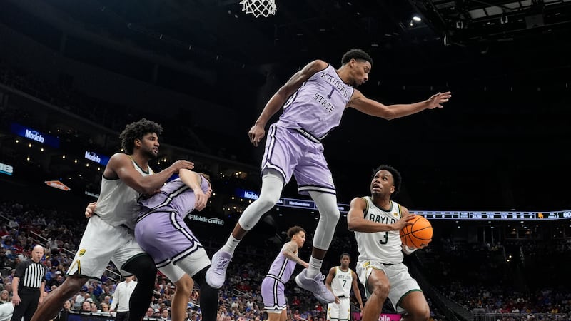 Baylor's Jeremy Roach (3) looks to the basket as Kansas State's David N'Guessan (1) defends...