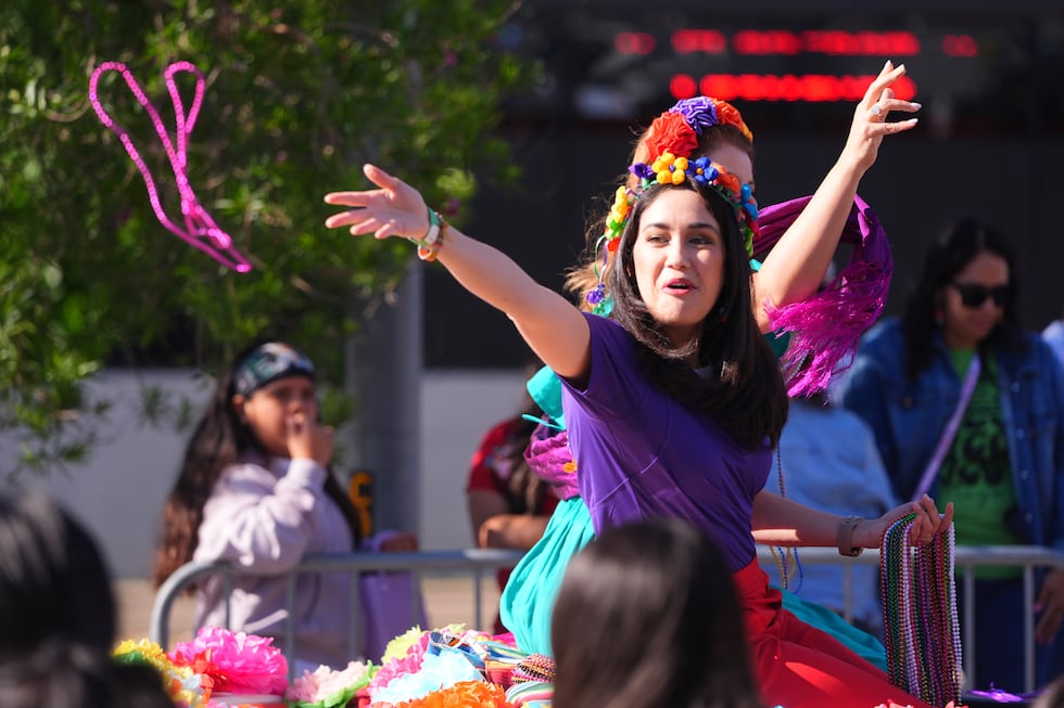 Beads are tossed from a float during a Cinco de Mayo parade in the Oak Cliff section of...