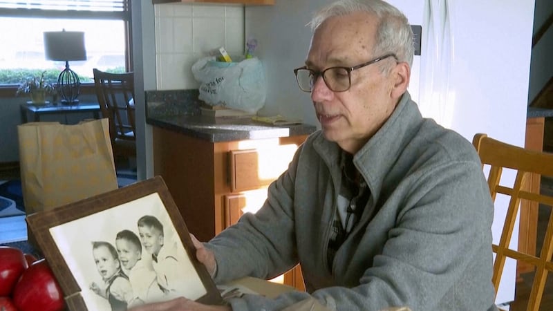 John Prevost points to an old photo of his brothers, including the newly elected Pope Leo XIV,...
