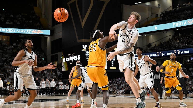 Vanderbilt guard Tyler Nickel (5) blocks a shot by Missouri guard Mark Mitchell (25) in the...
