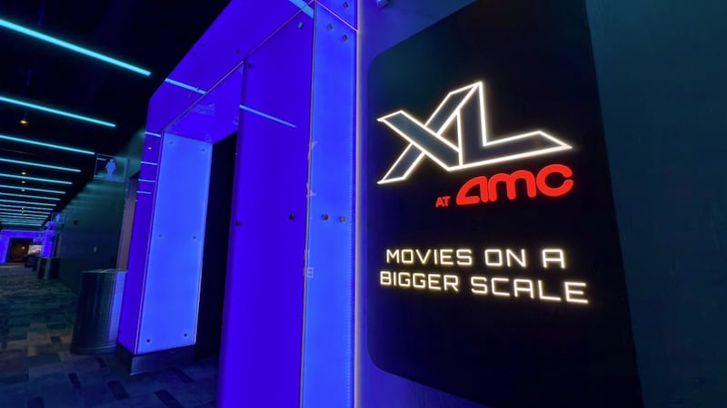 This picture, provided by AMC Theaters, shows a black hallway highlighted by a doorway bathed...