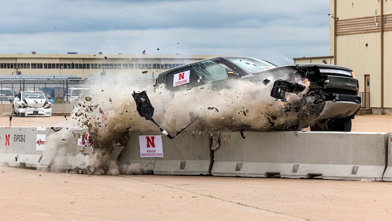 A Rivian electric pickup crashes against a lane barrier often used to protect road crews...