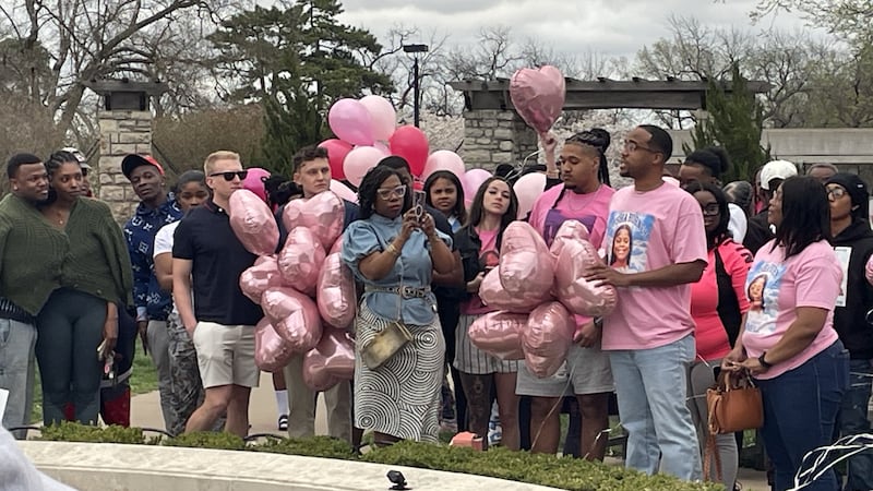 More than 100 people circled the fountain. Some were family or family friends. Others were...