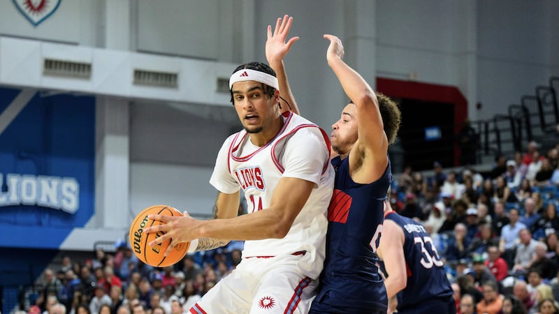 Loyola Marymount forward Jevon Porter (14) drives the ball while under pressure from Saint...